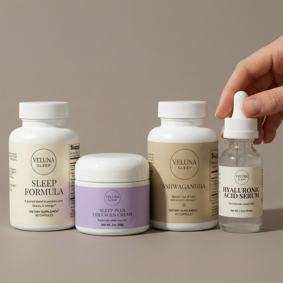 Veluna Sacred Soothe Full Bundle on taupe, a hand holding the Hyaluronic Acid Serum dropper beside three products