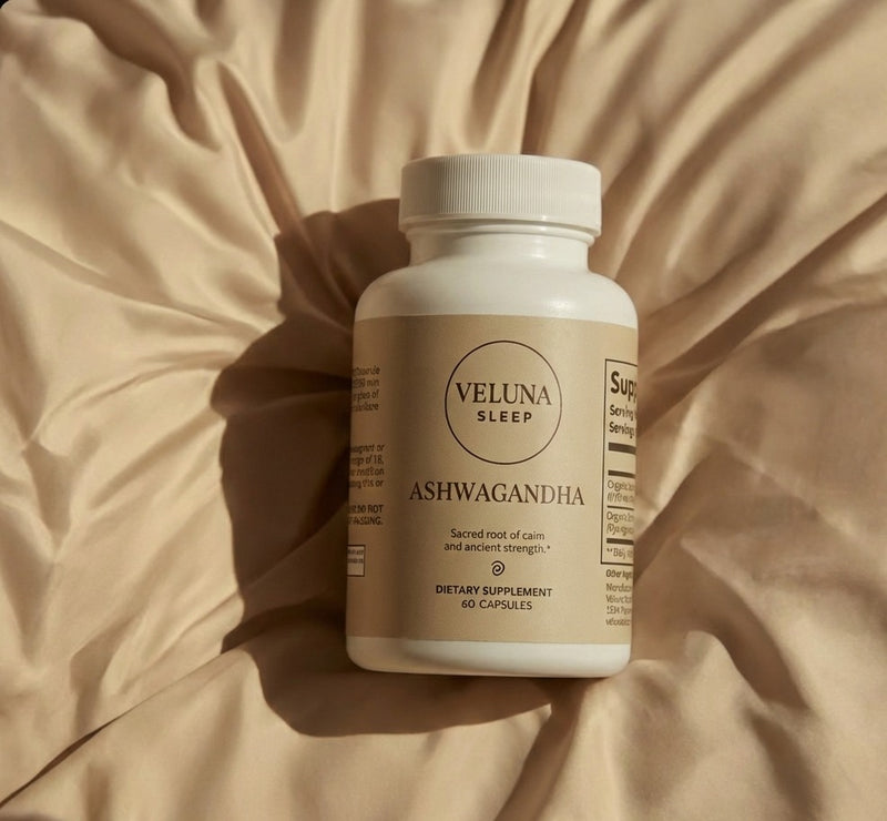 Veluna Organic Ashwagandha Capsules bottle lying on rumpled cream satin in warm light, seen from above