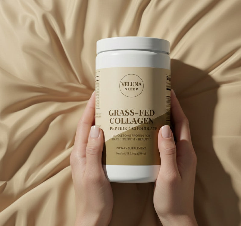 Veluna Grass-Fed Collagen Peptides, Chocolate, tub held upright in both hands over cream satin bedding