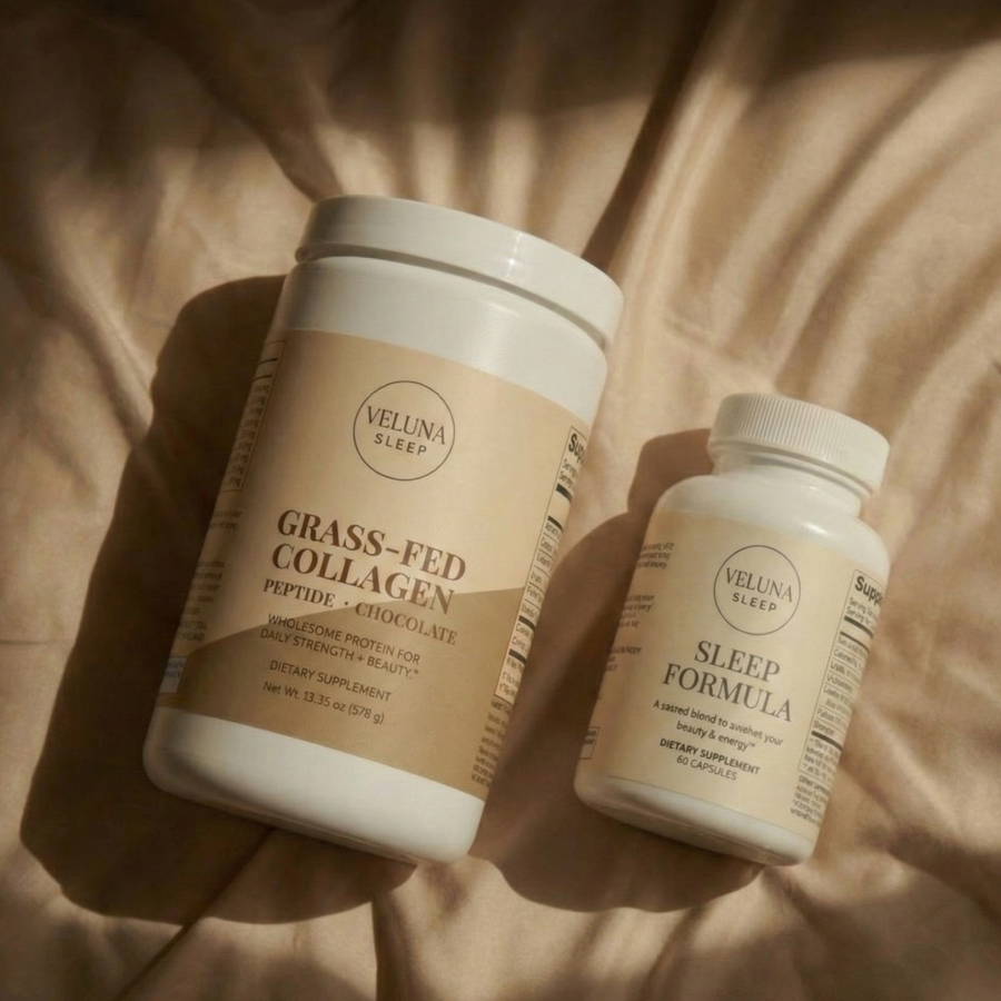 Veluna Deep Restore Booster Bundle, collagen tub and Sleep Formula bottle lying on sunlit cream bedding