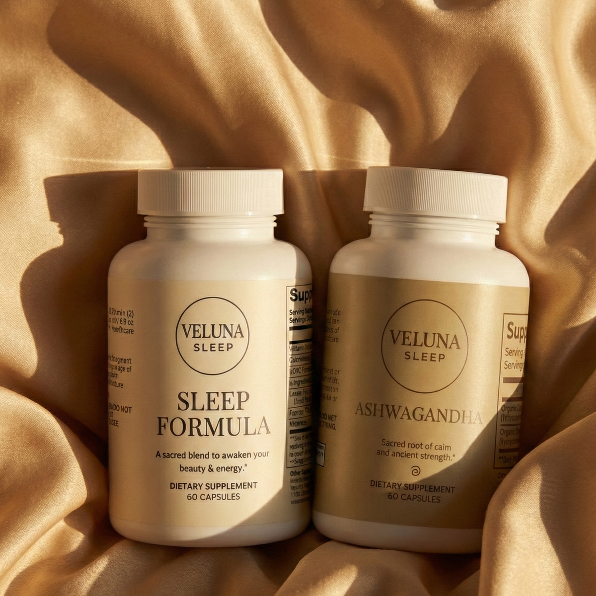 Veluna Sacred Soothe Booster Bundle, Sleep Formula and Ashwagandha bottles upright on draped golden satin