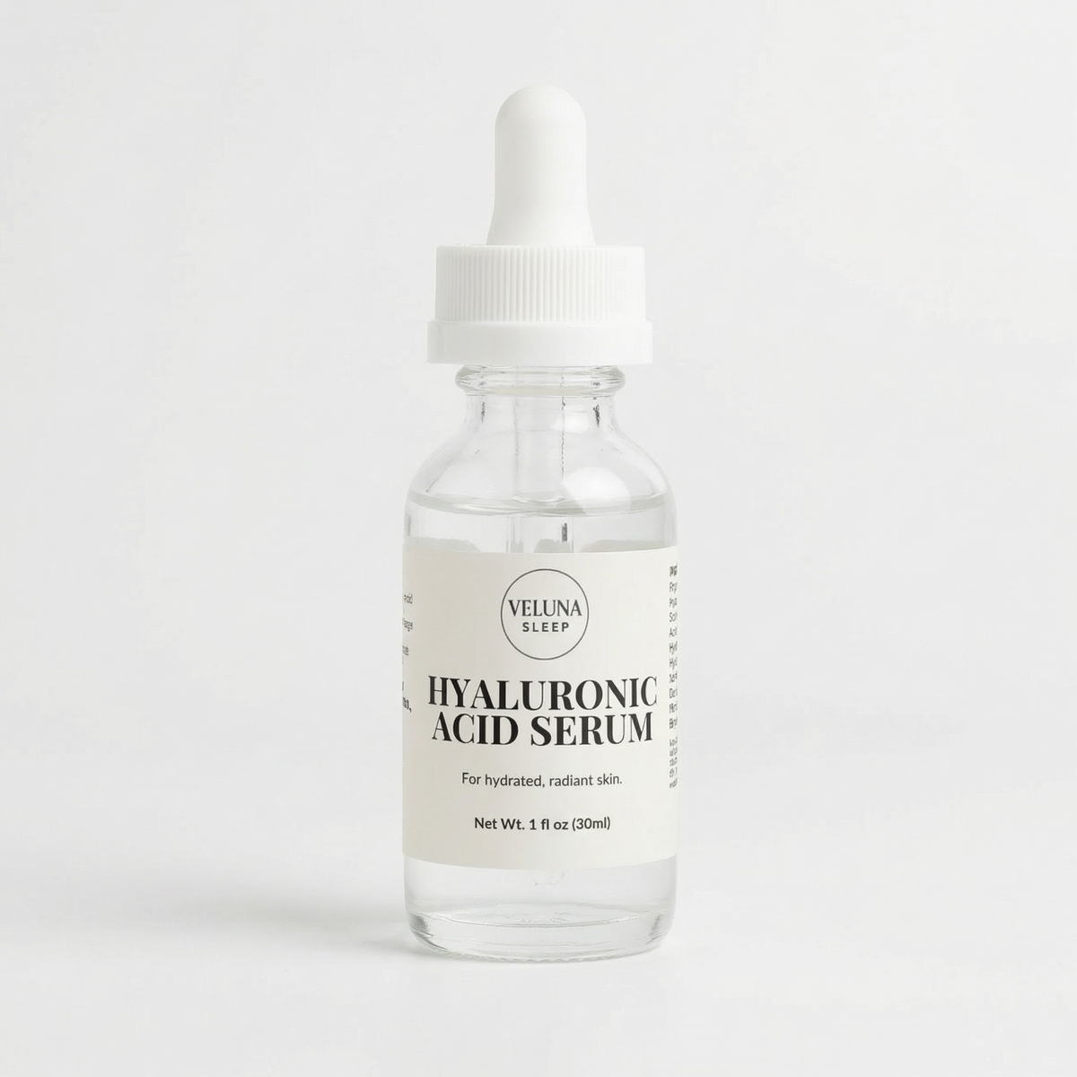 Veluna Hyaluronic Acid Serum, 1 fl oz clear glass dropper bottle with a cream label, pack shot on white