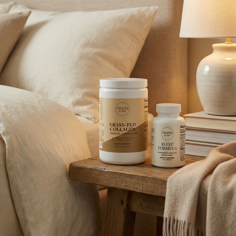 Veluna Deep Restore Booster Bundle, collagen tub and Sleep Formula bottle on a wooden bedside stool by a lamp