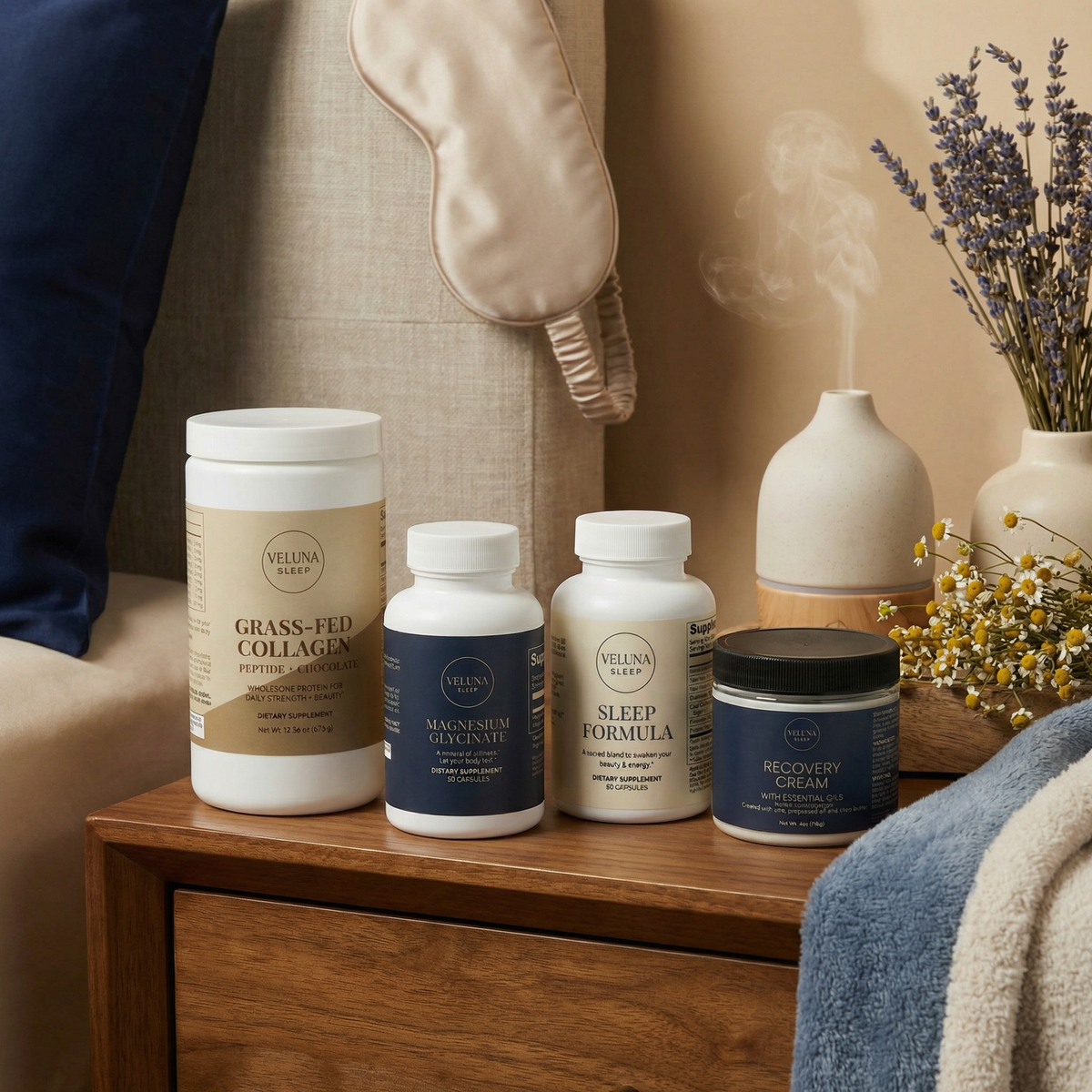 Veluna Deep Restore Full Bundle on a wooden nightstand with a silk eye mask, diffuser, lavender and chamomile