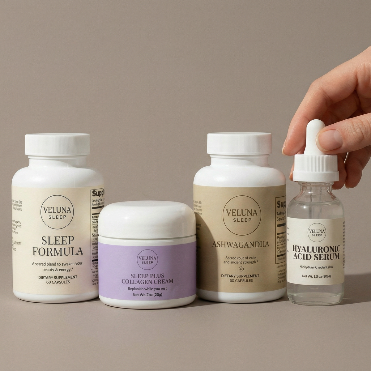 Veluna Sacred Soothe Full Bundle on taupe, a hand holding the Hyaluronic Acid Serum dropper beside three products