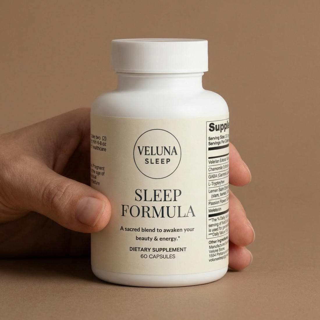Veluna Sleep Formula Capsules bottle held in one hand against a tan backdrop, side label partly visible