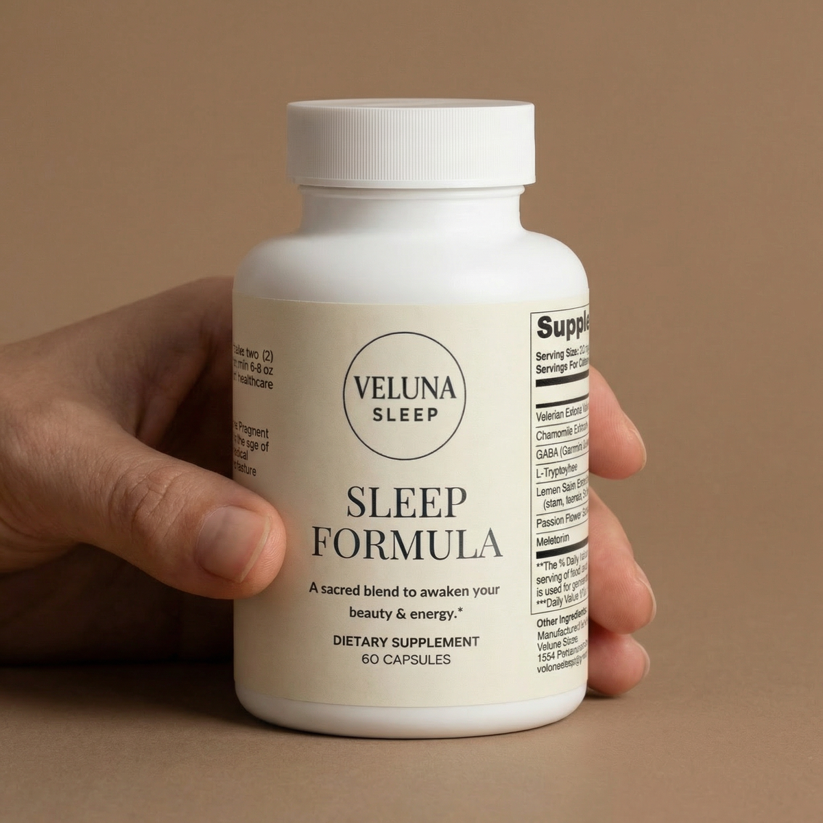 Veluna Sleep Formula Capsules bottle held in one hand against a tan backdrop, side label partly visible
