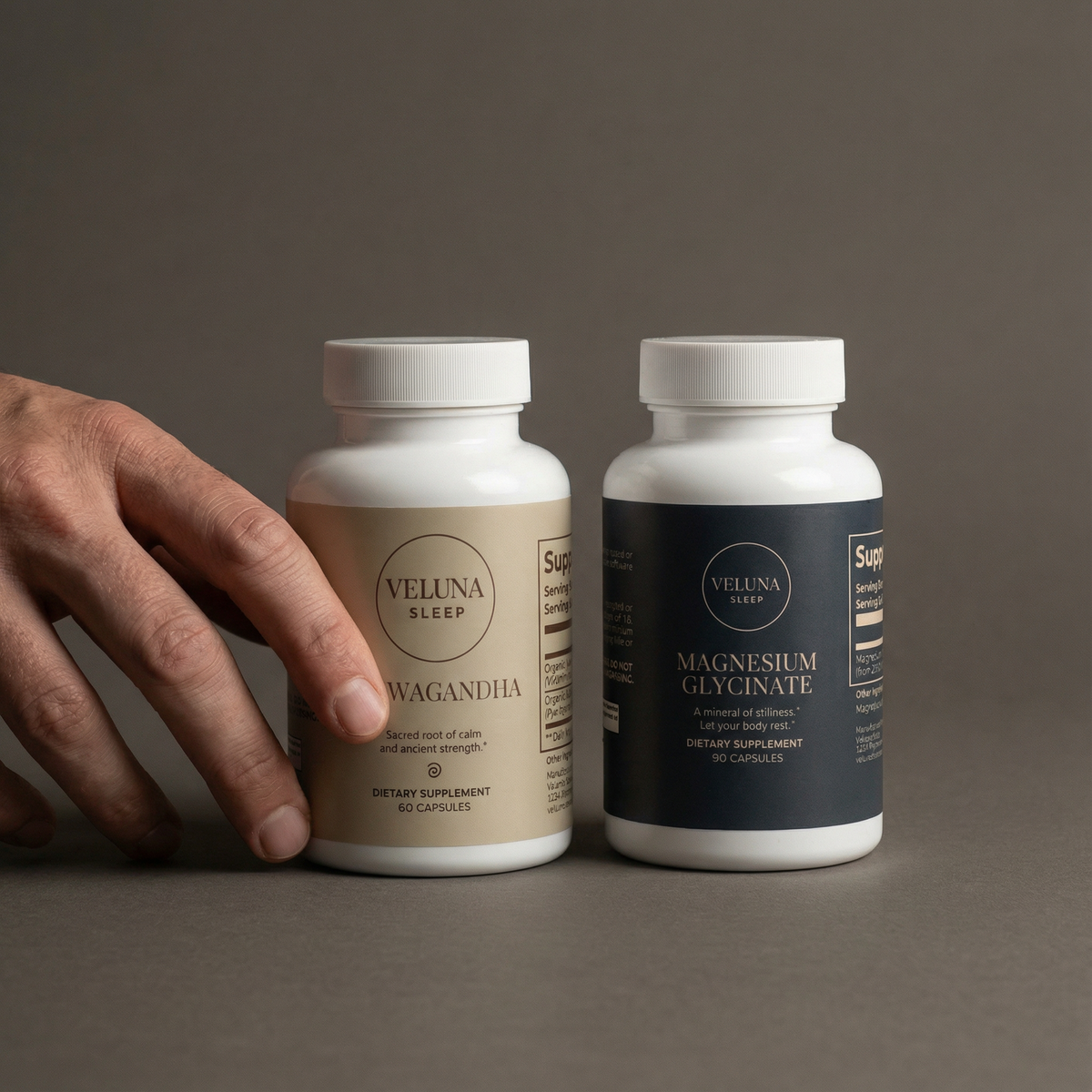 Veluna Mind Calm Starter Bundle on grey, a hand touching the Ashwagandha bottle beside Magnesium Glycinate
