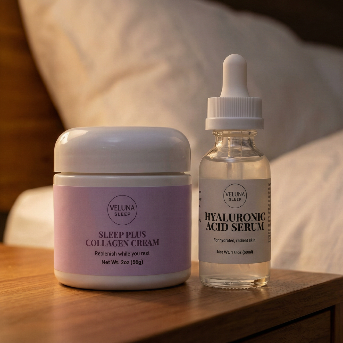 Veluna Sacred Soothe Starter Bundle, night cream jar and serum bottle on a wooden nightstand by a pillow