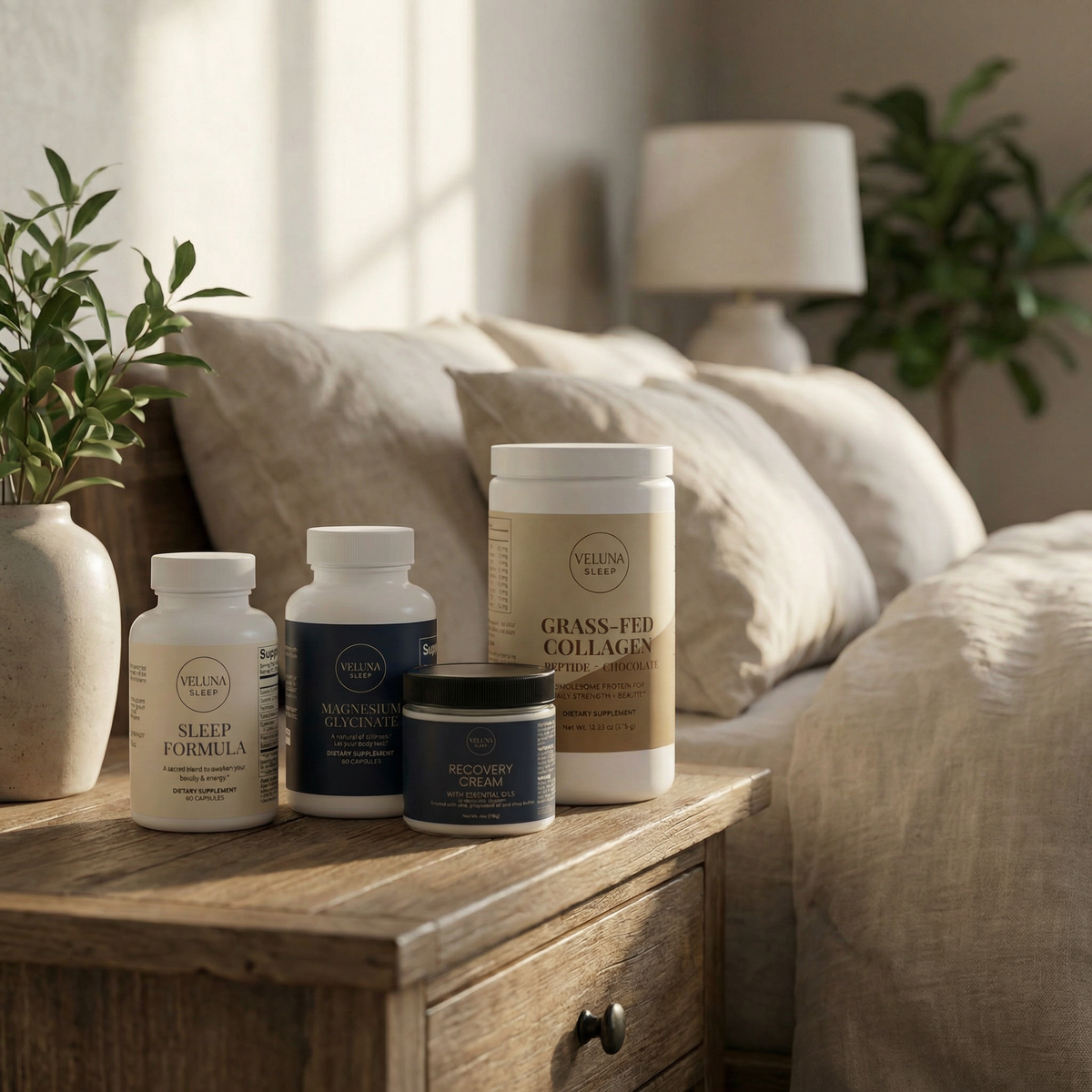 Veluna Deep Restore Full Bundle, all four products on a rustic nightstand beside linen pillows and a green plant