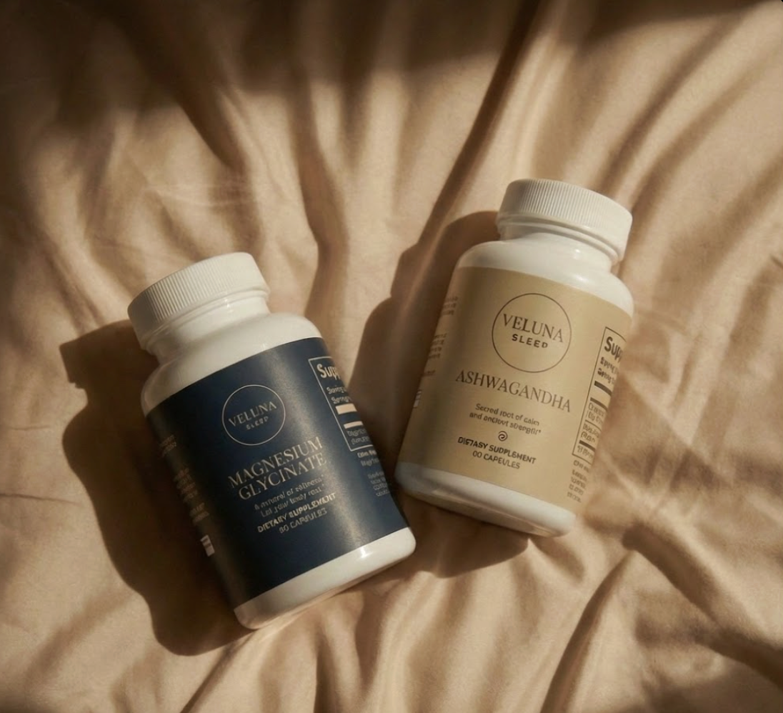 Veluna Mind Calm Starter Bundle, Magnesium Glycinate and Ashwagandha bottles lying on sunlit cream bedding