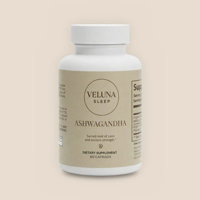 Veluna Organic Ashwagandha Capsules, 60-count bottle with a beige label, pack shot on a warm linen background