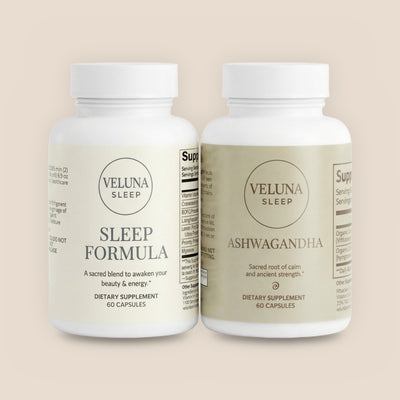 Veluna Sacred Soothe Booster Bundle, Sleep Formula and Organic Ashwagandha Capsules bottles on white, on a warm linen background